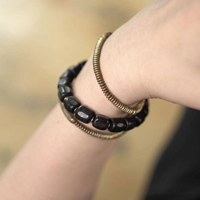 Stacked three-strand Buddhist bracelet close-up showing bead arrangement and texture