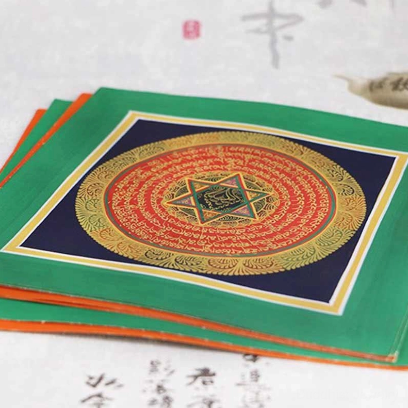 Stacked mandala thangka scrolls with green outer borders, red and gold concentric patterns – authentic handmade Buddhist spiritual artworks