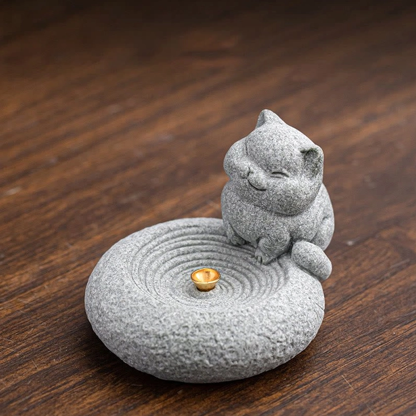 Standing cat incense burner empty golden socket on wooden tea table three-quarter view