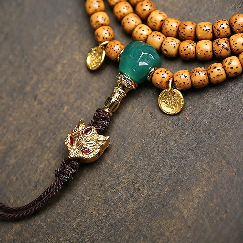 Close-up of Star Moon Bodhi Seeds showing aged spotted texture with fox head metal charm and gold coin pendants