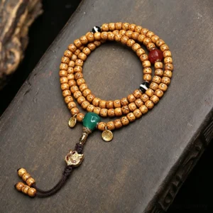 Star Moon Bodhi Seed 108 bead Buddhist prayer mala with green stone guru bead and tassel charm, overhead view
