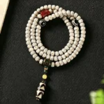 Star Moon Bodhi Seed Dzi Bead Buddhist Prayer Bracelet flat lay showing detailed bead patterns and sacred amulet pendant