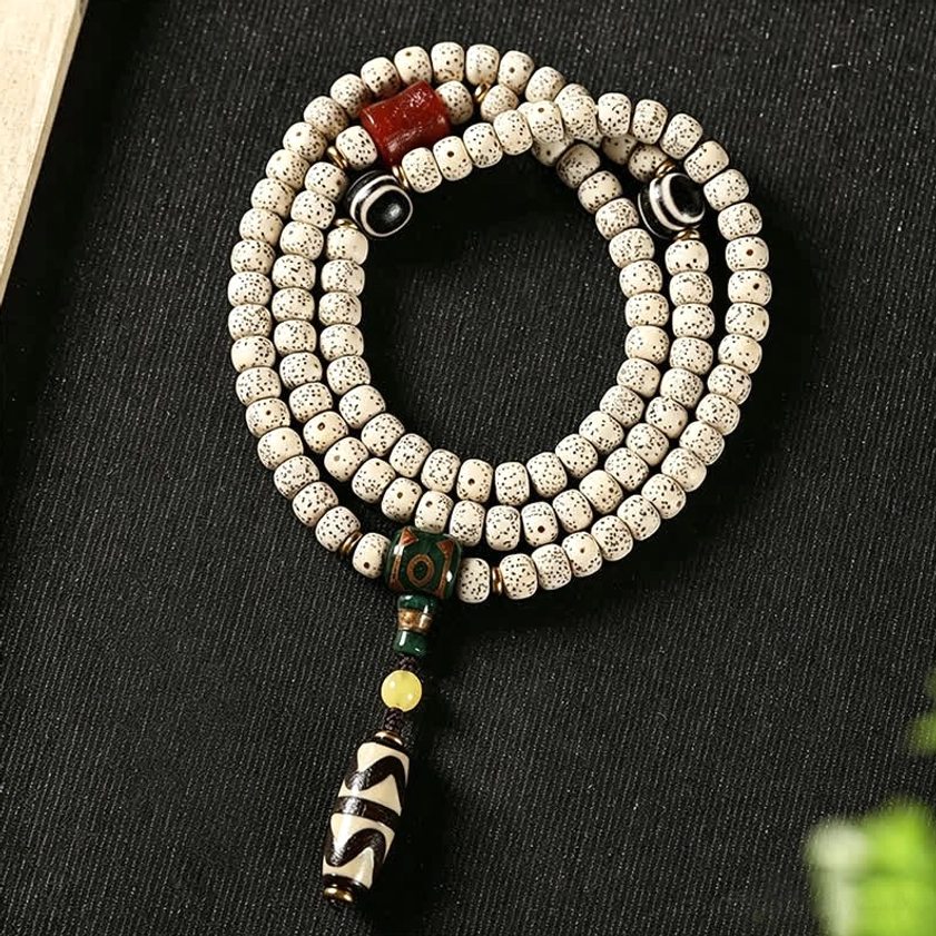 Star Moon Bodhi Seed Dzi Bead Buddhist Prayer Bracelet flat lay showing detailed bead patterns and sacred amulet pendant