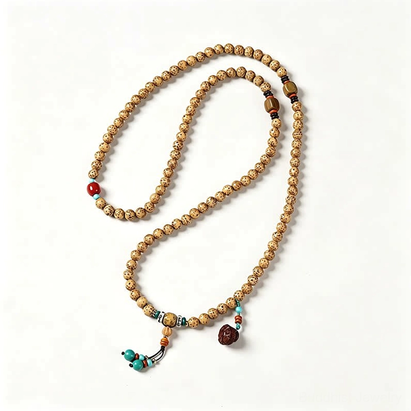 Single strand Star Moon Bodhi Seed Buddhist mala with red spacer bead and turquoise tassel on light background