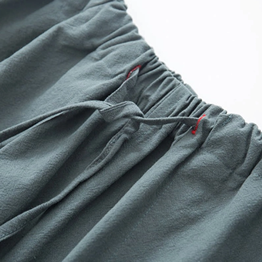 Full length side view of steel blue linen zen tang suit pants with natural waist and drawstring closure