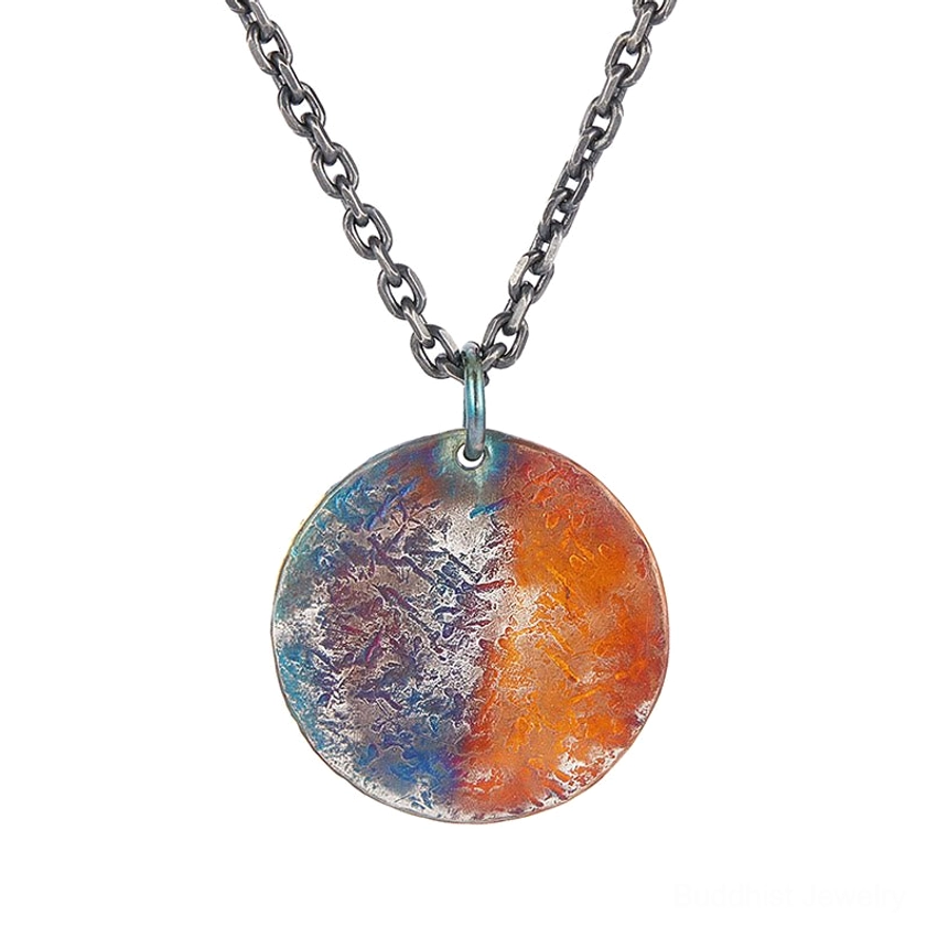 Unadorned sterling silver round coin pendant showing natural patina finish and warm-cool color tones, ready for engraving or customization
