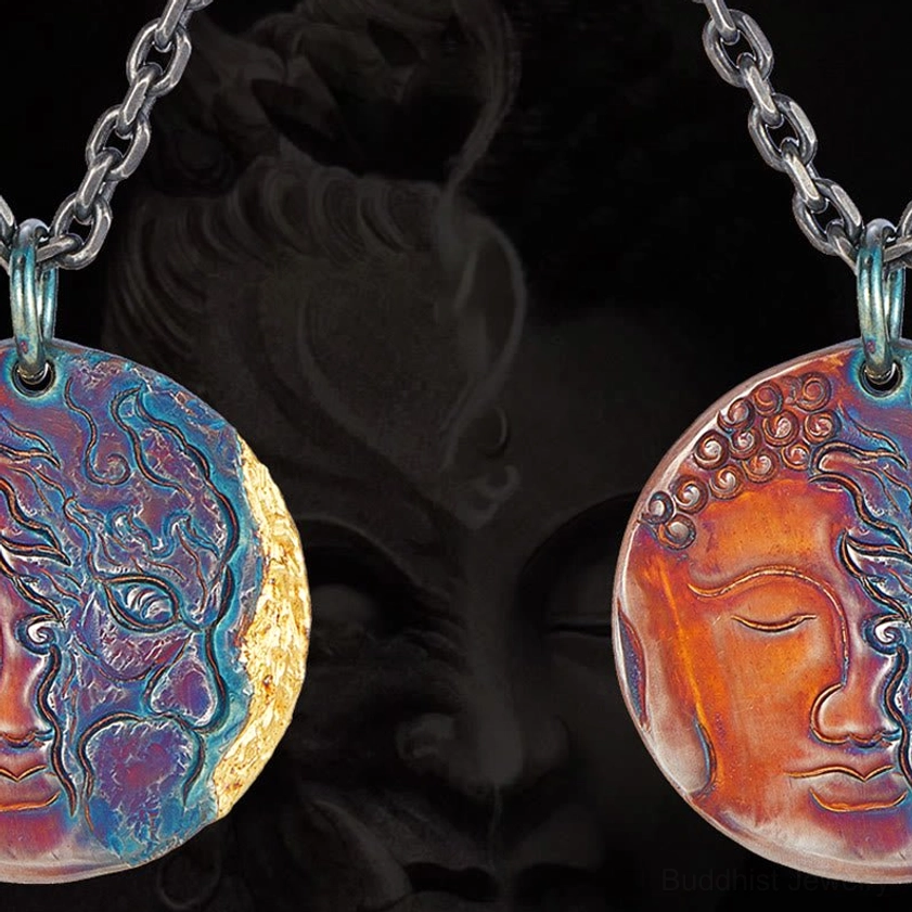 Two handcrafted sterling silver Buddhist pendants shown in flat lay, demonstrating patina finish and dark twisted chain, front-facing view