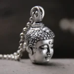 999 sterling silver Buddha head pendant close-up side view, vintage aged silver finish with intricate carved details