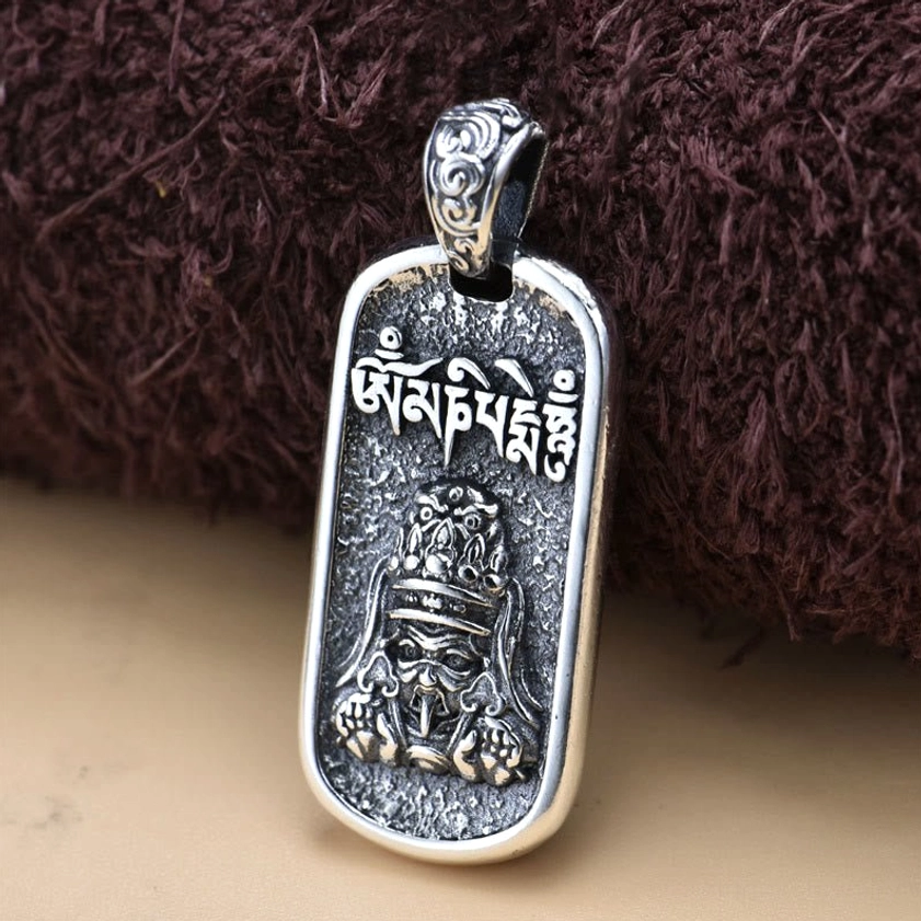 925 sterling silver Buddhist wealth deity pendant showing aged vintage finish and detailed deity engraving