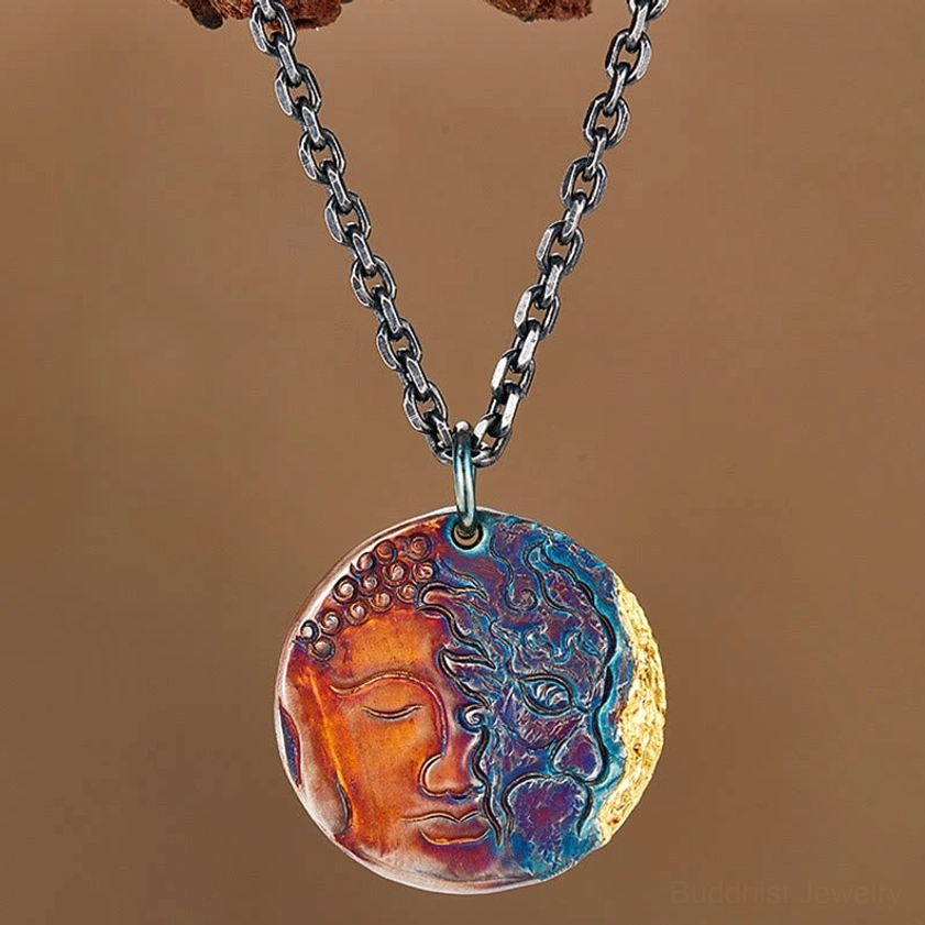 Hanging sterling silver Buddha demon coin pendant necklace with dual-face engraving and mixed tone patina against neutral background