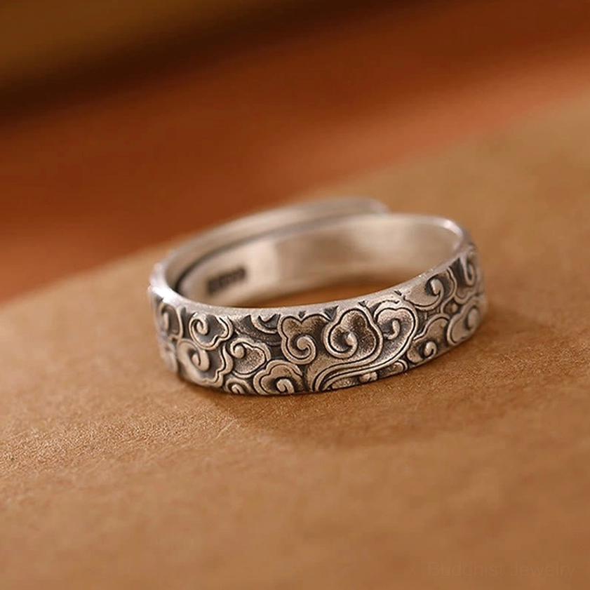 Sterling silver Buddhist adjustable ring showing adjustable open band mechanism and comfortable fit design with engraved spiritual symbols