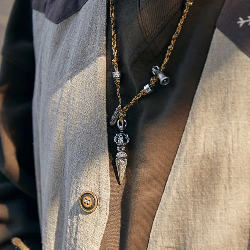 Handcrafted Sterling Silver Dorje Pendant Necklace Displayed on Brown Linen Shirt, Authentic Buddhist Jewelry for Spiritual Practice