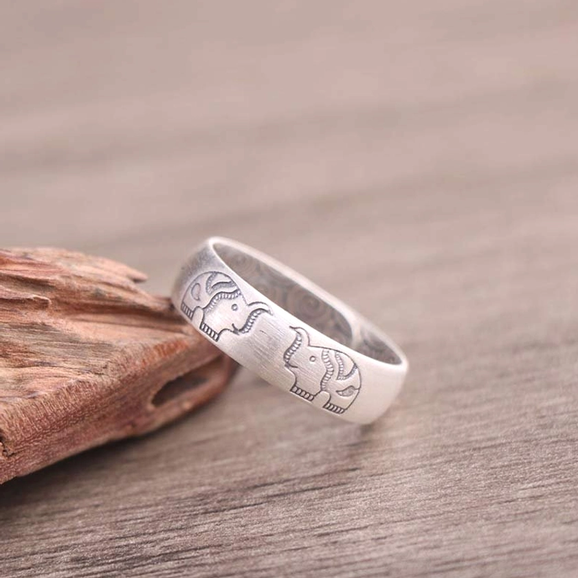 Silver elephant blessed ring with intricate engraving and open adjustable design, side oblique view