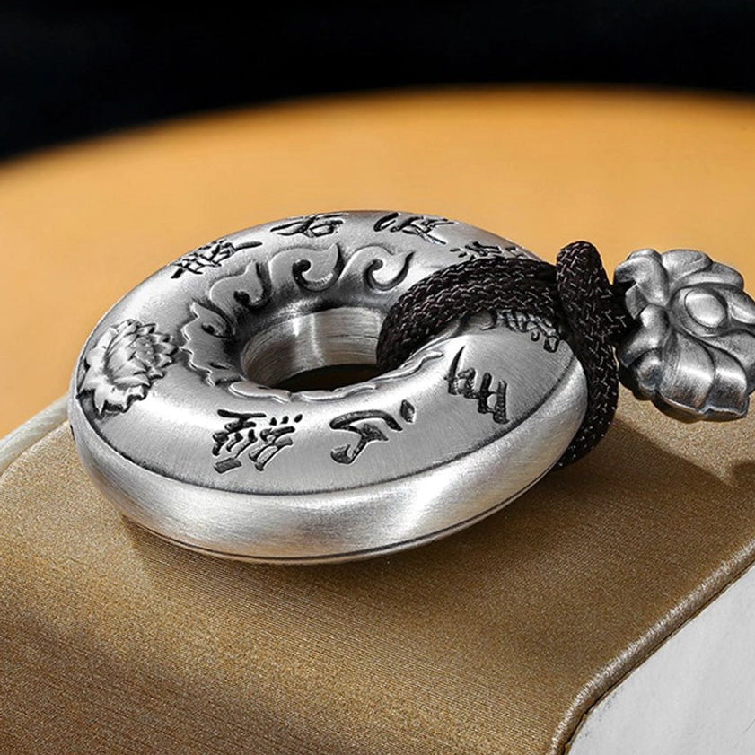 Side Angle View of Sterling Silver Heart Sutra Peace Buckle Pendant - Curved Solid Design with Engraved Patterns