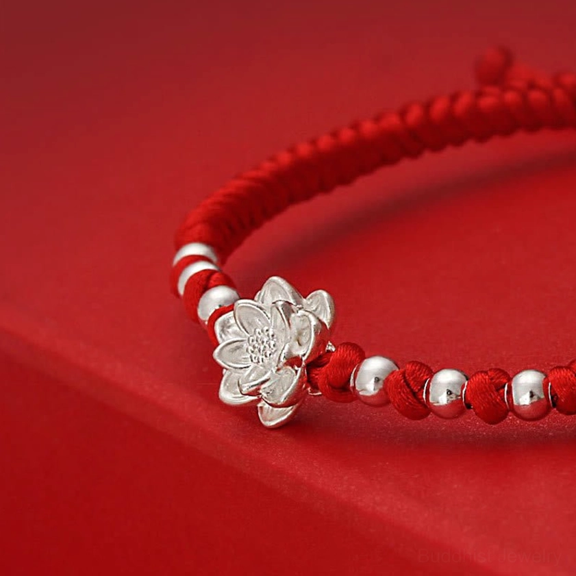 Close-up macro detail of 999 sterling silver lotus pendant with multiple silver bead accents