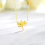 925 sterling silver lotus pendant necklace with rose quartz drop and zircon accent on white background flat lay