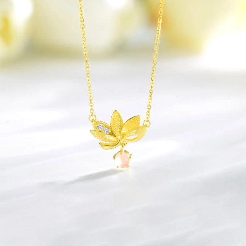 925 sterling silver lotus pendant necklace with rose quartz drop and zircon accent on white background flat lay