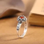 925 sterling silver lotus red agate ring front view with engraved sutra band on antique finish desktop