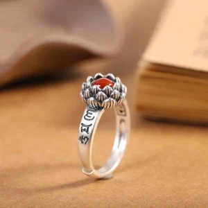 925 sterling silver lotus red agate ring front view with engraved sutra band on antique finish desktop