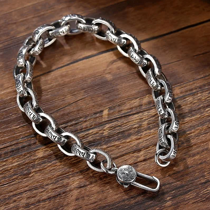 Compact sterling silver Om Mani Padme Hum engraved Buddhist bracelet on white background showing delicate chain design