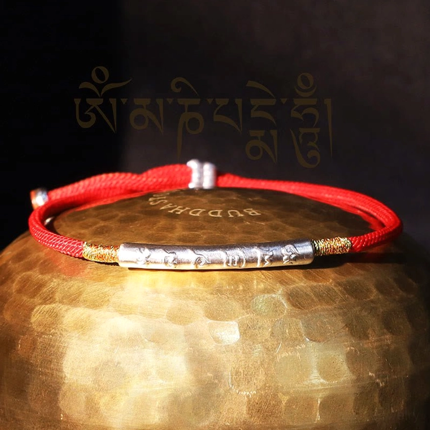 Sterling silver Om Mani Padme Hum red string bracelet with sacred mantra engraving, professional product shot