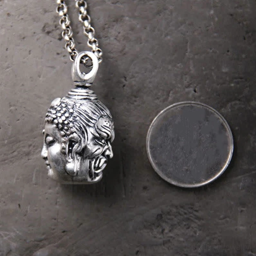 Double-faced Buddhist pendant with silver chain shown next to coin for size reference, compact pendant dimensions