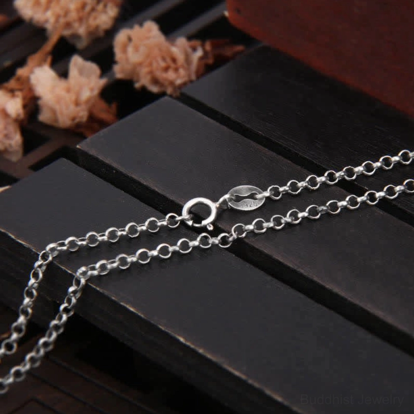 925 sterling silver rolo chain necklace flat lay, showing spring ring clasp and uniform chain links with dried flowers