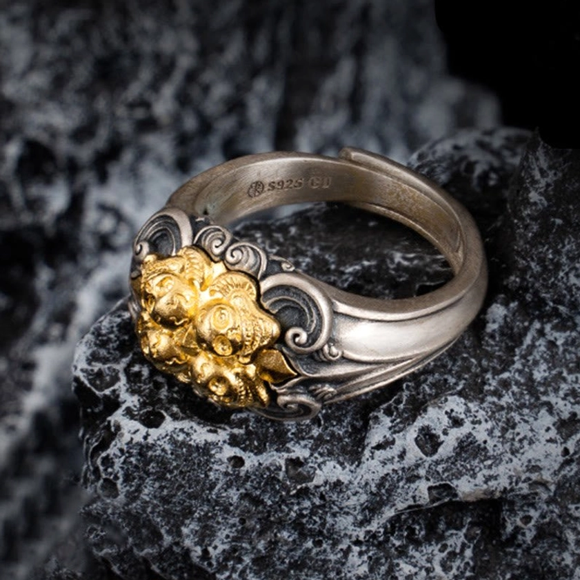 Adjustable sterling silver skull ring side angle showing S925 hallmark and ornate scroll patterns