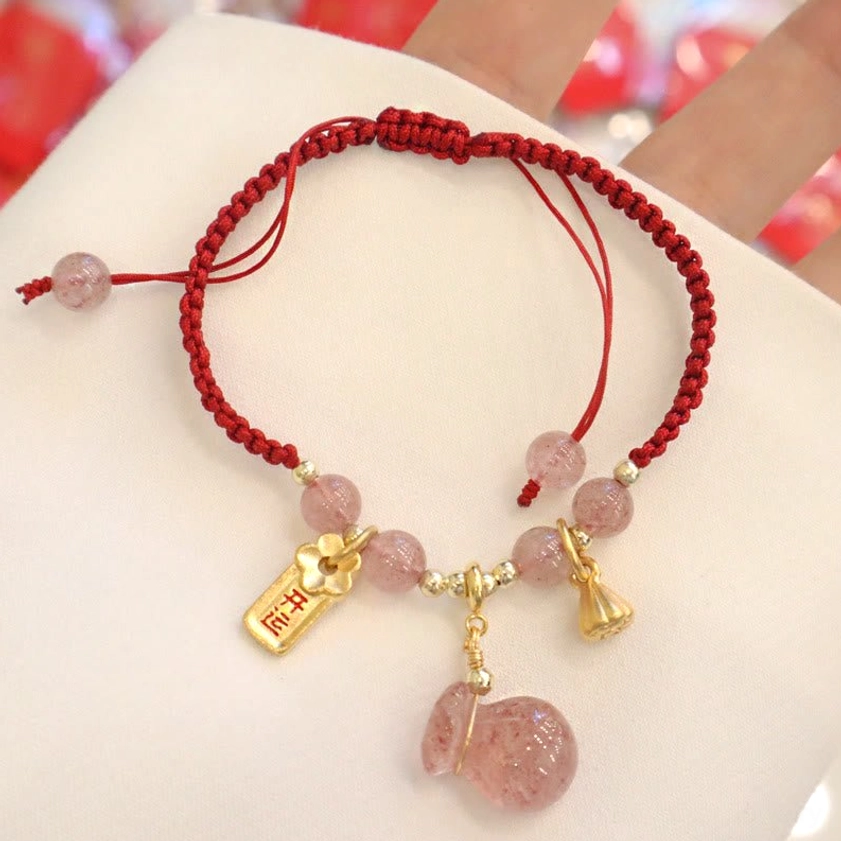 Adjustable Buddhist Red String Bracelet with Strawberry Quartz and Lotus Charm - Top Down View