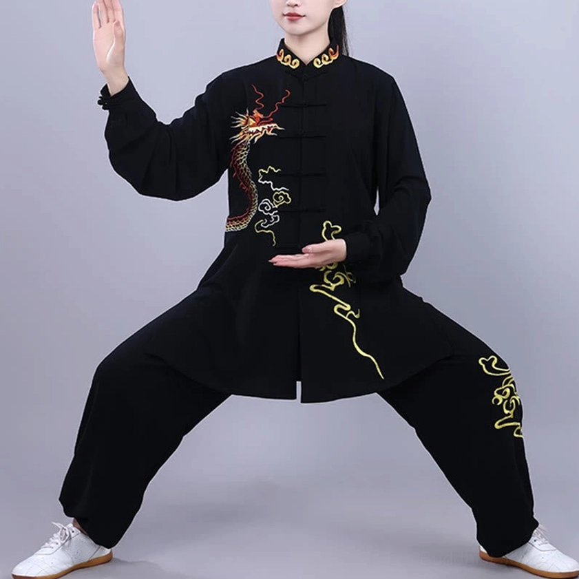 Man practicing tai chi in black dragon embroidered uniform with frog buttons