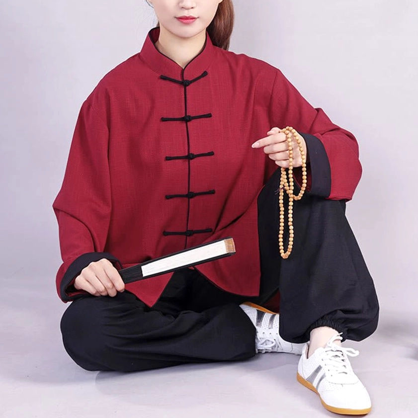 Seated tai chi practice set display with prayer beads and folding fan, burgundy linen-cotton top with frog buttons