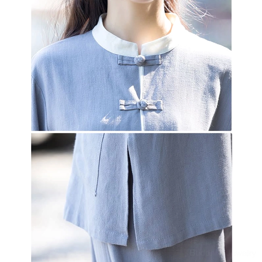 Close-up detail of tai chi top showing traditional Chinese frog buttons and linen fabric texture in light gray