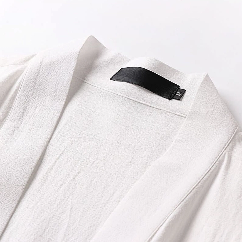 Tan wrap kimono meditation top with tie closure and three-quarter sleeves display