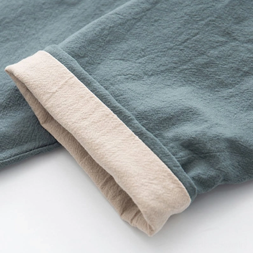 Functional patch pocket detail on steel blue linen tang shirt demonstrating practical zen meditation wear design