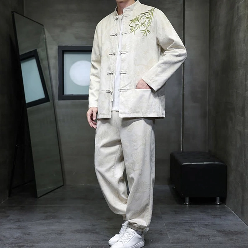 Front three-quarter view of Dragon Bamboo Tang suit with hand in pants pocket, embroidery detail