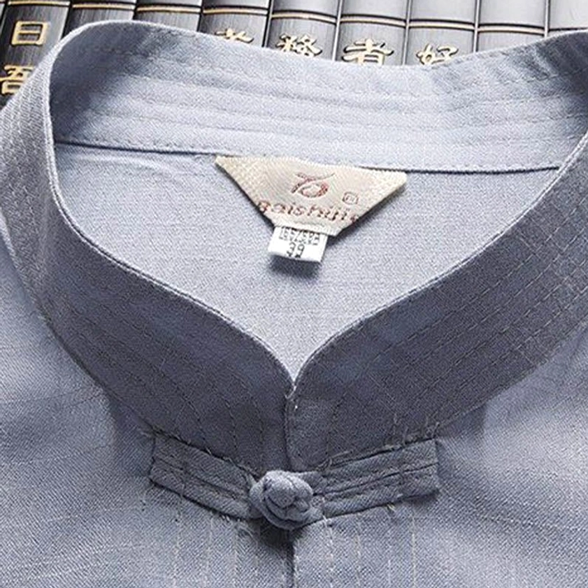 Close-up of Tang suit stand collar and frog button detail with brand label