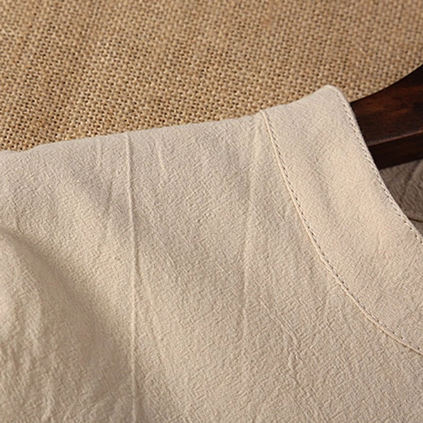 Tang suit collar stitching detail showing beige cotton linen fabric and neat tailoring