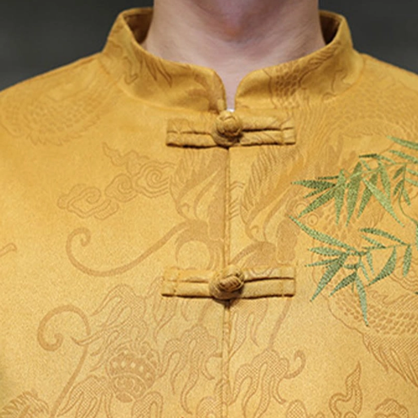 Tang suit close-up showing material quality, weave texture, and embroidered bamboo detail