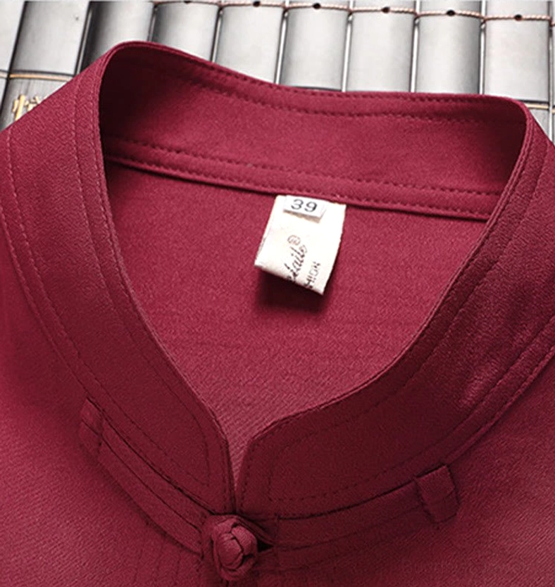 Tang suit inner collar close-up - vintage background showing interior size tag and traditional frog button at placket bottom for authenticity