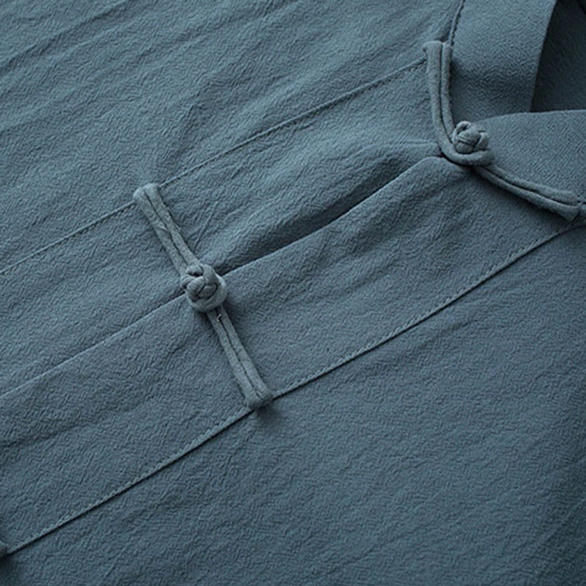 Tang suit front frog button closure detail showing knotted traditional Chinese knot buttons and cotton fabric texture