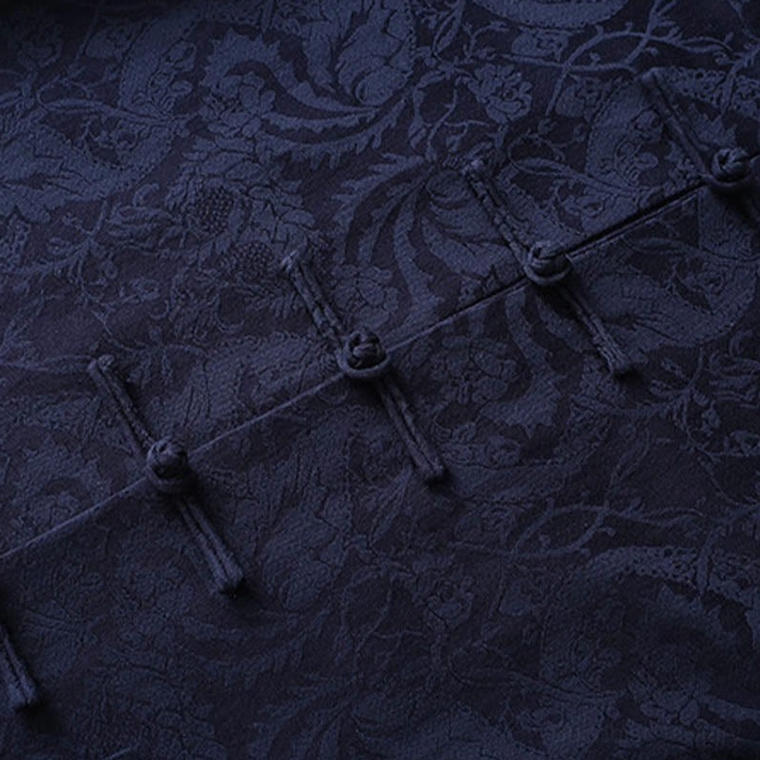 Tang suit jacket front placket showing multiple traditional frog buttons and dense jacquard vine texture