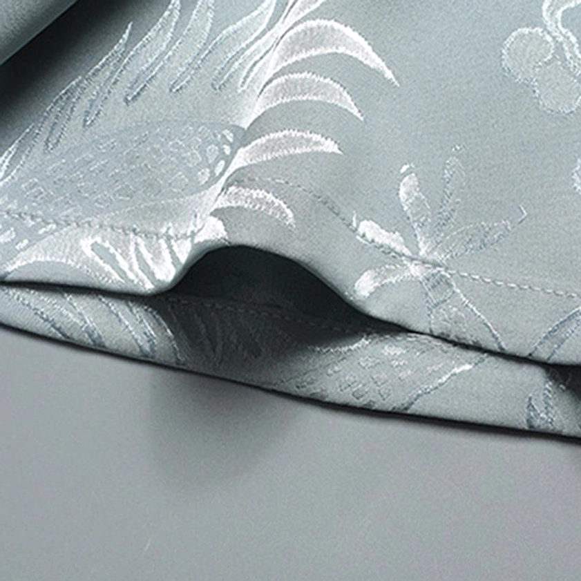Dragon and botanical jacquard weave fabric texture on Tang suit hem