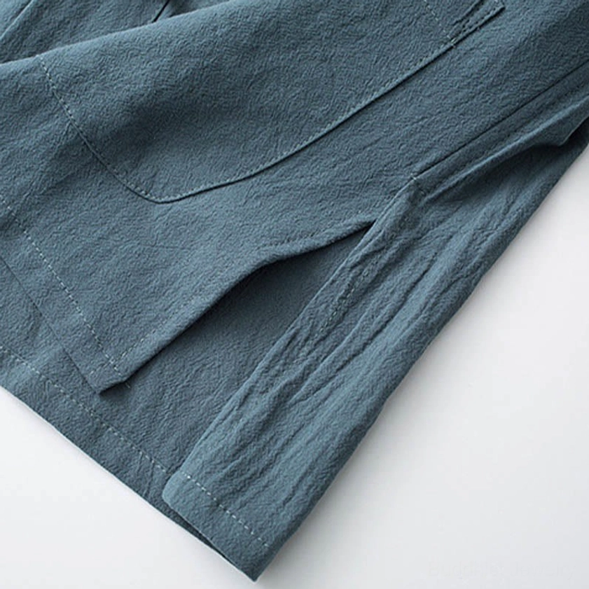 Tang suit hem and side slit detail showing traditional split design and fabric edge finishing