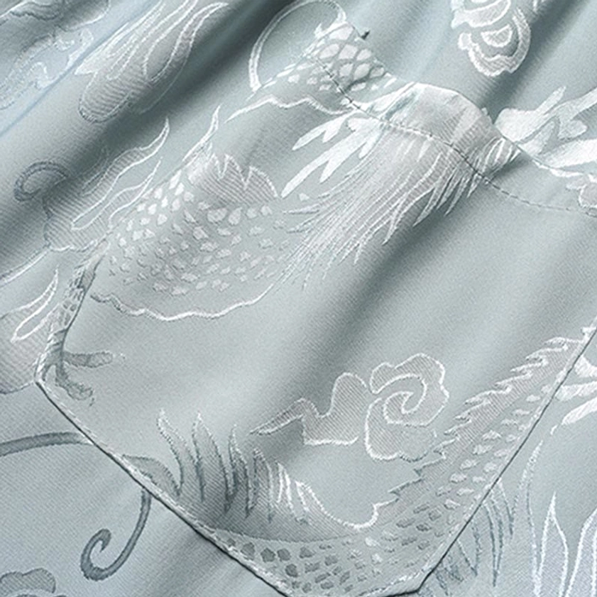 Dragon jacquard weave fabric on Tang suit pants leg close-up
