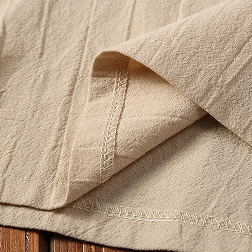 Close-up of Tang suit seam and overlocked edge stitch on cotton linen fabric