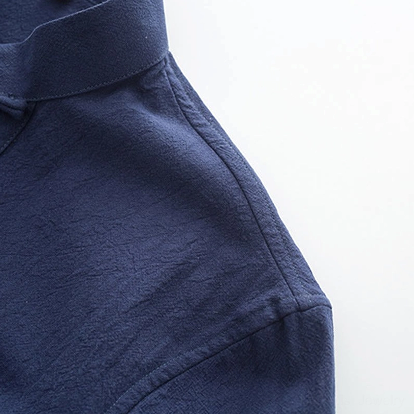 Tang suit shoulder and collar construction showing neat stitching and stand collar design on navy cotton