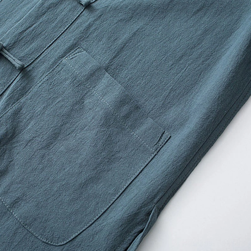 Tang suit patch pocket detail showing clean seams and teal cotton fabric construction