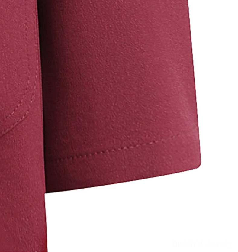 Tang suit sleeve hem close-up - finished long sleeve edge with neat folded stitching on maroon non-stretch polyester fabric