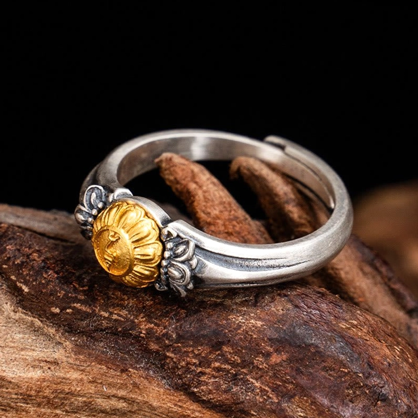 Tara protection ring front view with two-tone silver and gold plating detail against natural wood background