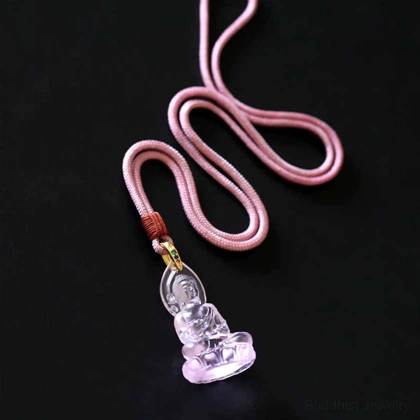 Light blue Tathagata Buddha pendant necklace showing transparent Liuli crystal pendant with woven cord